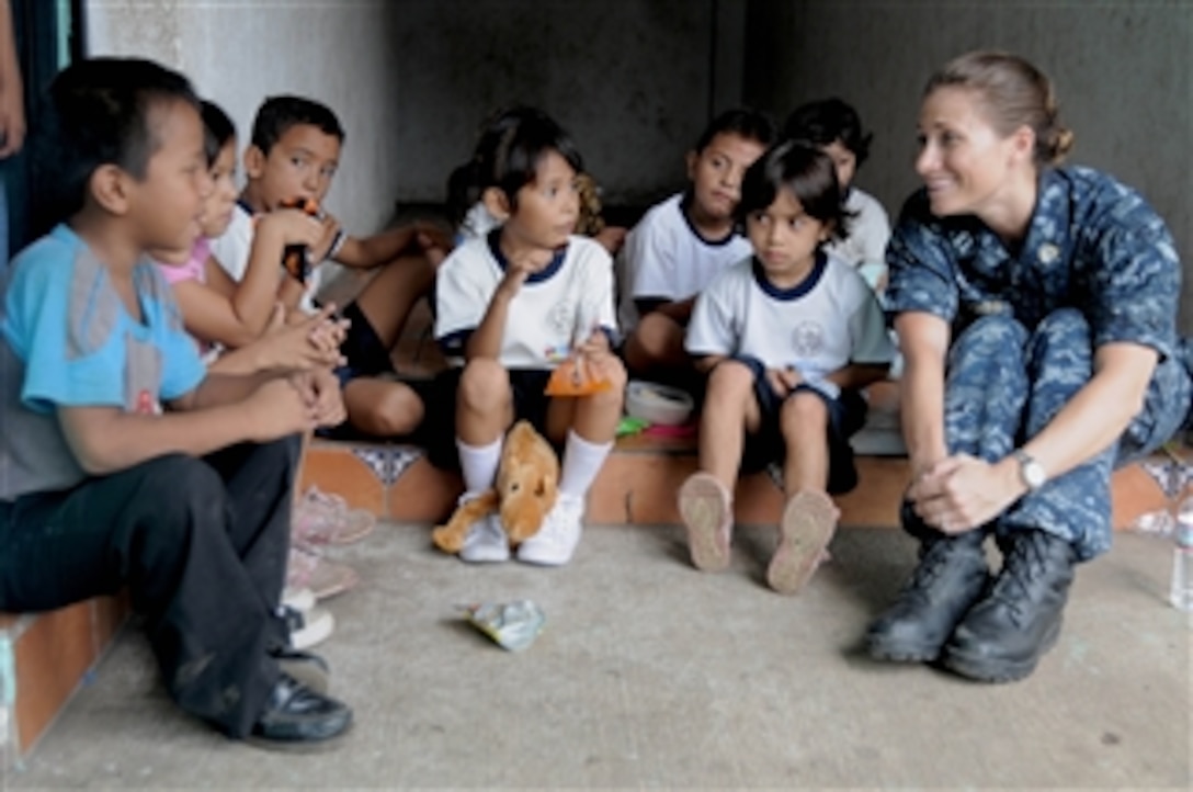 U.S. Navy Lt. Audrey Koecher (right), the judge staff advocate for Continuing Promise 2011, talks with children during a community relations event at Escuela Republica de Japon in Puerto San Jose, Guatemala, on July 8, 2011.  Continuing Promise is a regularly scheduled mission to countries in Central and South America and the Caribbean, where the U.S. Navy and its partnering nations work with host nations and a variety of governmental and nongovernmental agencies to train in civil-military operations.  