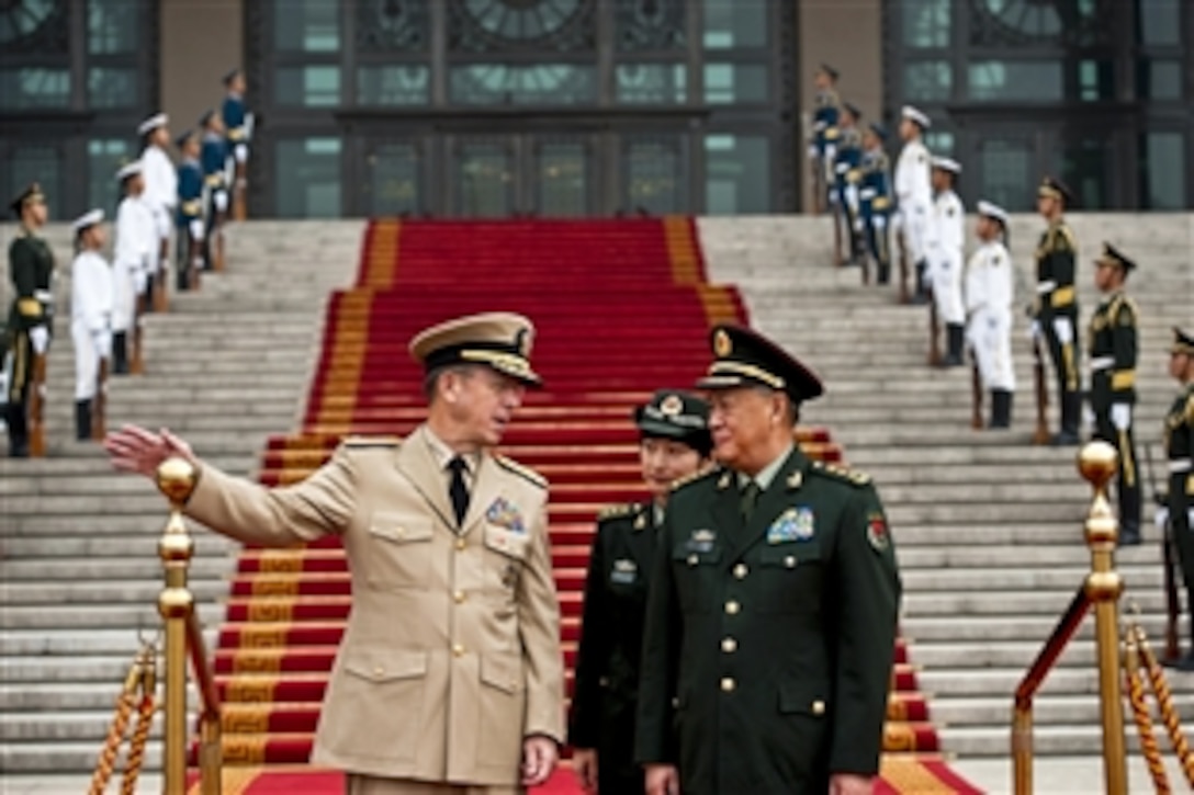 U.S. Navy Adm. Mike Mullen, chairman of the Joint Chiefs of Staff, speaks with Chinese Gen. Chen Bingde, chief of the Peoples Liberation Army's General Staff, during a ceremony welcoming Mullen to Beijing, July 11, 2011. Mullen is on a three-day trip to the country to meet with counterparts and Chinese leaders.