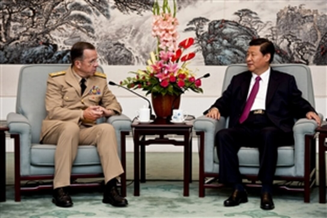 U.S. Navy Adm. Mike Mullen, chairman of the Joint Chiefs of Staff, speaks with Chinese Vice President Xi Jinping in Beijing, July 11, 2011.
