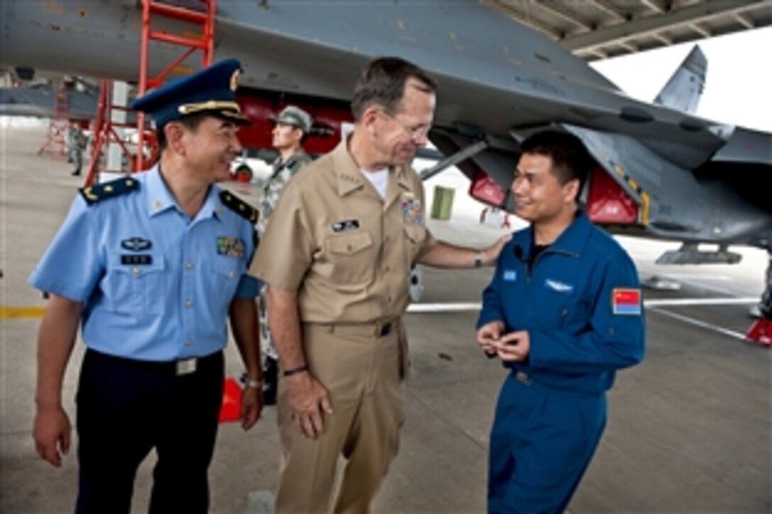 U.S. Navy Adm. Mike Mullen, chairman of the Joint Chiefs of Staff, thanks a Chinese People's Liberation Army Air Force airman after a tour of a Sukhoi Su-27 Fighter at the 19th Air Division in Shandong, China, July 12, 2011. Mullen is on a three-day trip to the country to meet with counterparts and Chinese leaders.
