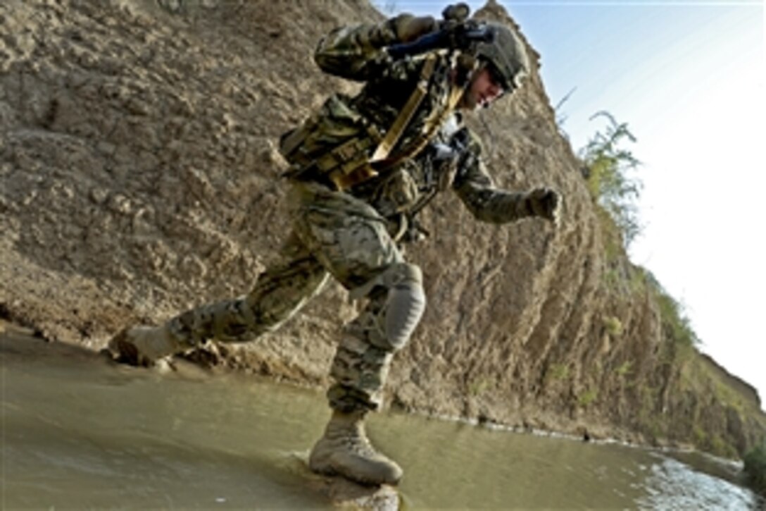 U.S. Army Sgt. 1st Class Robert Russell crosses the Tarnek River in Qalat City, Afghanistan, July 9, 2011. Russell, a platoon sergeant, is a member of Provincial Reconstruction Team Zabul's security force. Team members work with Afghan officials to to improve governance, stability and development throughout the province.