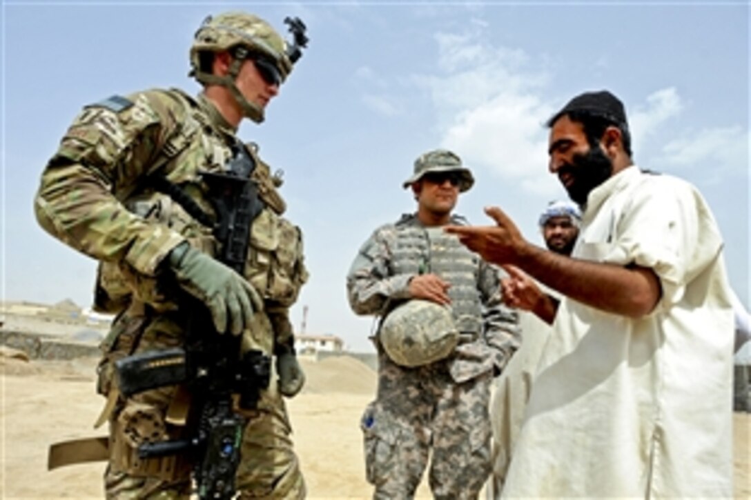 U.S. Air Force 1st Lt. Michael Stuart, civil engineer, speaks with local villagers about a construction site during a quality assurance visit in Qalat City, Afghanistan, July 8, 2011. Stuart, a civil engineer, is a member of Provincial Reconstruction Team Zabul.