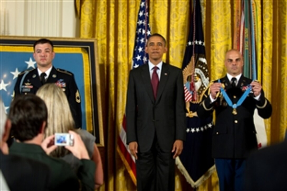President Barack Obama stands at attention prior to presenting the Medal of Honor to Army Sgt. 1st Class Leroy Petry at the White House in Washington, D.C., July 12, 2011. 