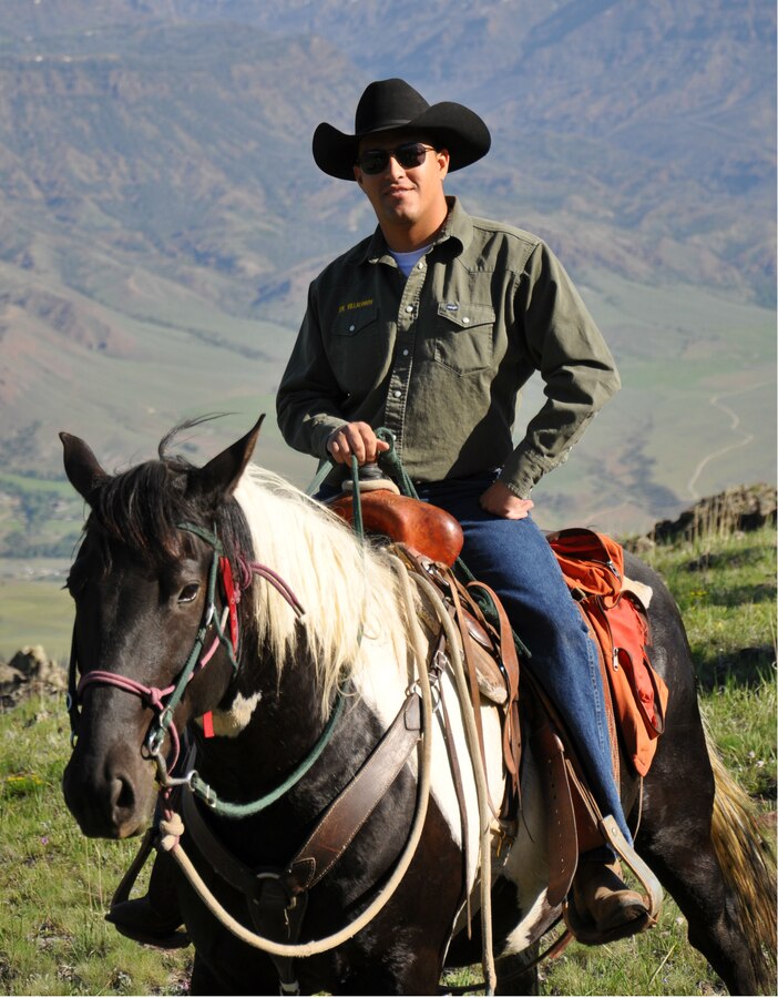 Corporal Anthony Villalobos, a native of Los Angeles, is currently the longest serving member of the last remaining mounted ceremonial unit in the Marine Corps, the Mounted Color Guard aboard Marine Corps Logistics Base Barstow, Calif. The corporal is relaxing in the saddle in the ranging hills outside Cody, Wyo., before taking part in the opening ceremonies for the Cody Stampede Rodeo during July 2011.