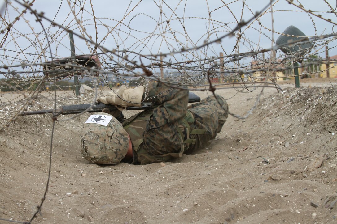 The sounds of gun fire and screaming filled the air as fully geared-up recruits from Company G, Marine Corps Recruit Depot San Diego, Calif., attacked the bayonet assault course July 12 with M-16A2 service rifles in hand.