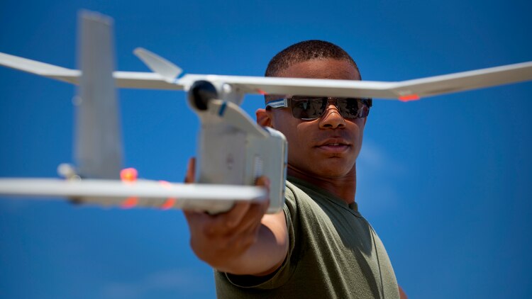 Lance Cpl. Anthony Nolley-Crosson, an intelligence clerk with 3rd Battalion, 3rd Marine Regiment, prepares to launch an RQ-11B Raven unmanned aircraft system during UAS flight operations at Marine Corps Training Area Bellows, Hawaii, July 12, 2011. In only a few short months, Nolley-Crosson and fellow 3/3 Marines will use the Raven in Afghanistan to gather intelligence, allowing battalion leaders to analyze and use the information for reconnaissance, surveillance and target acquisition.