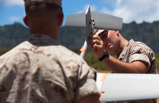 Lance Cpl. Michael Cuneo, a rifleman with India Company, 3rd Battalion, 3rd Marine Regiment, examines an RQ-11B Raven unmanned aircraft system before UAS flight operations at Marine Corps Training Area Bellows, Hawaii, July 12, 2011. Though Cuneo specializes as a rifleman, his grip has temporarily transferred from his rifle to the controls of the Raven. During 3/3’s upcoming fall deployment to Afghanistan, Cuneo, from Newcastle, Calif., will fulfill duties as a company-level intelligence cell Marine for India Co. “Gathering intelligence makes an impact on a daily basis,” Cuneo said. “If I can gather intelligence for my squad and send it up to higher, I can make an impact at a larger level than just in my squad’s area of operation.”