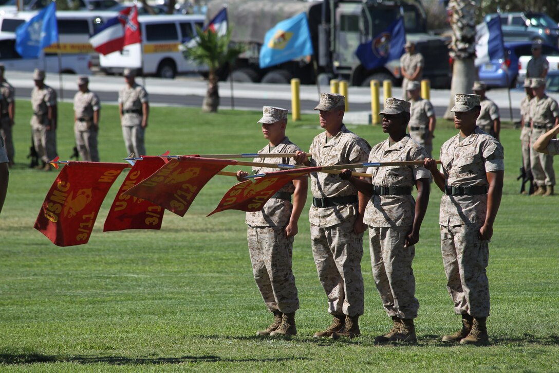 The company guidon bearers present the company guidons during the “officers center” element of 3rd Battalion, 11th Marine Regiment, change of command ceremony at Lance Cpl. Torrey L. Gray Field July 13, 2011. During the ceremony, Lt. Col. Eduardo Abisellan relinquished command to Lt. Col. Christopher Escamilla.