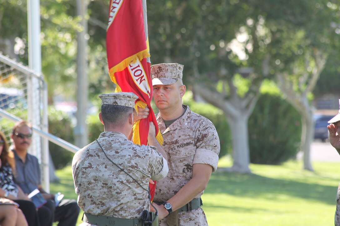 Lt. Col. Christopher Escamilla accepts the battalion colors from Lt. Col. Eduardo Abisellan during the 3rd Battalion, 11th Marine Regiment, change of command ceremony at Lance Cpl. Torrey L. Gray Field July 13, 2011. The exchange of the battalion’s colors signifies the shift in command from one Marine to the other.