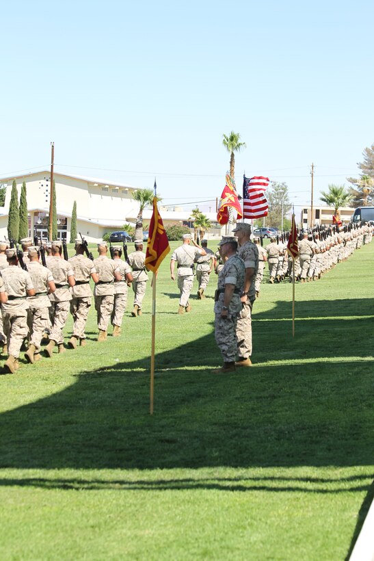 The battalion marches past Lt. Col. Eduardo Abisellan [left], outgoing commander, and Lt. Col. Christopher Escamilla, incoming commander, during the “Pass in Review” element of the 3rd Battalion, 11th Marine Regiment, change of command ceremony at Lance Cpl. Torrey L. Gray Field July 13, 2011. “Pass in Review” provides the first opportunity for the new commander to review the battalion.
