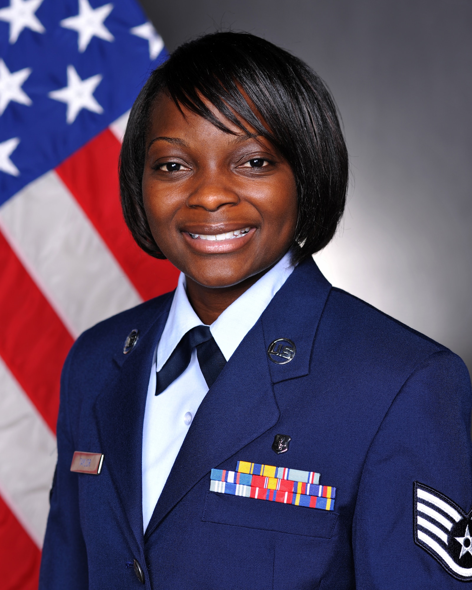 YOKOTA AIR BASE, Japan -- Staff Sgt. Raven Taylor, 374th Medical Operations Squadron medical technician, smiles for an official photo at Yokota Air Base, Japan, July 14, 2011. Sergeant Taylor was named one of the Air Force's 12 Outstanding Airmen of the Year for 2011 for her work at her previous base, Eielson Air Force Base, Alaska.(U.S. Air Force photo/Senior Airman Andrea Salazar)