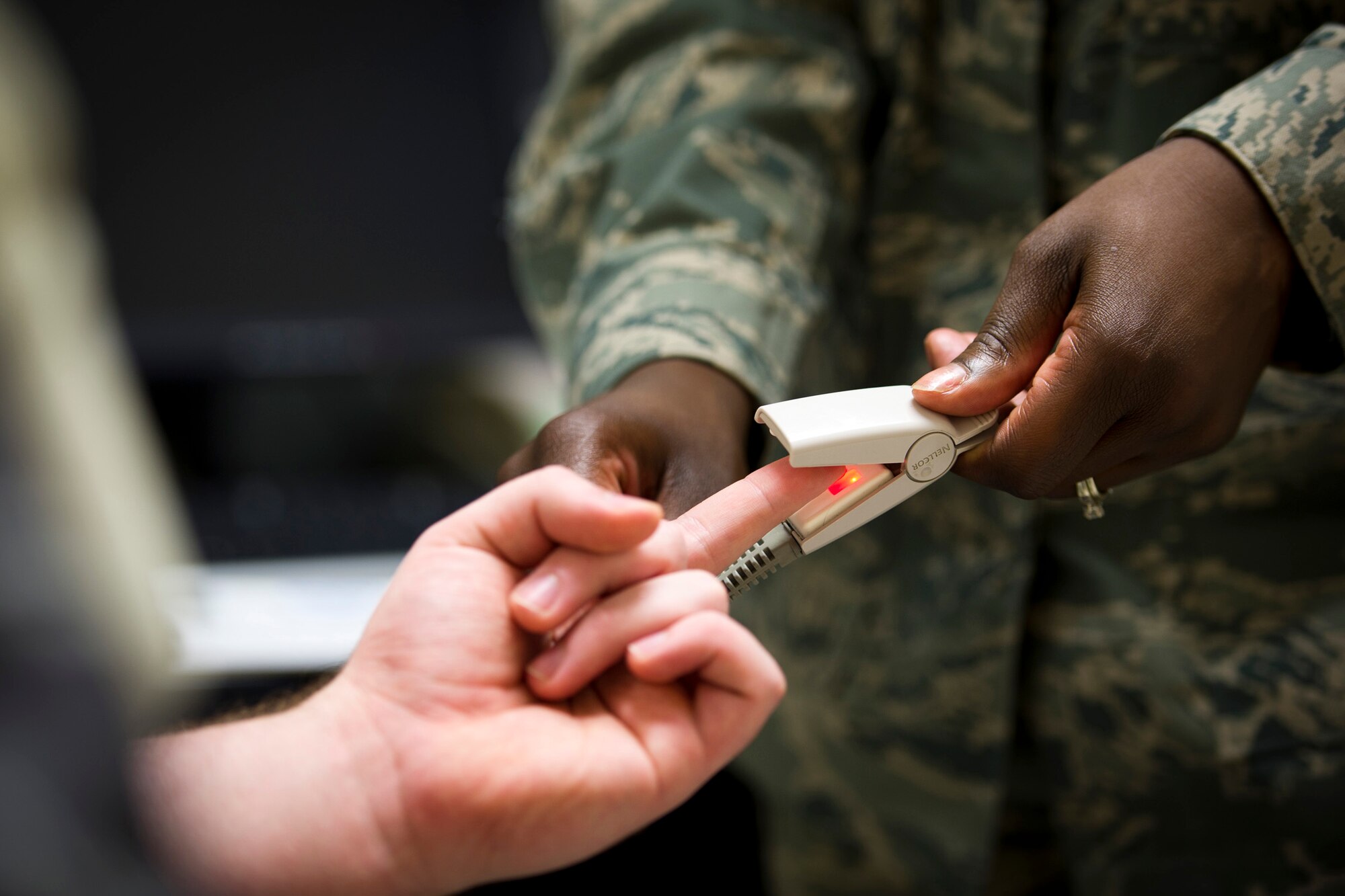 YOKOTA AIR BASE, Japan -- Staff Sgt. Raven Taylor, 374th Medical Operations Squadron, clips a pulse oximeter to a patient's fingertip at Yokota Air Base, Japan, July 8, 2011. Sergeant Taylor was named one of the Air Force's 12 Outstanding Airmen of the Year for 2011 for her work at her previous base, Eielson Air Force Base, Alaska. (U.S. Air Force photo/Staff Sgt. Samuel Morse)
