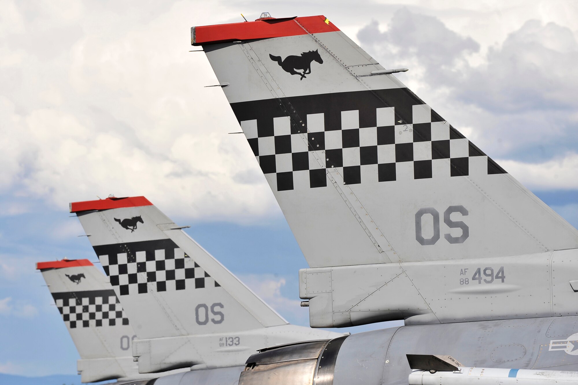 The checker tailed F-16 Fighting Falcons from the 36th Fighter Squadron stand at the ready during RED FLAG-Alaska 11-2 July 6, 2011, Eielson Air Force Base, Alaska. RF-A is a two week long exercise designed to give pilots aerial combat training. The 36th Fighter Squadron is based at Osan Air Base, Republic of Korea. (U.S. Air Force photo/Staff Sgt. Christopher Boitz)
