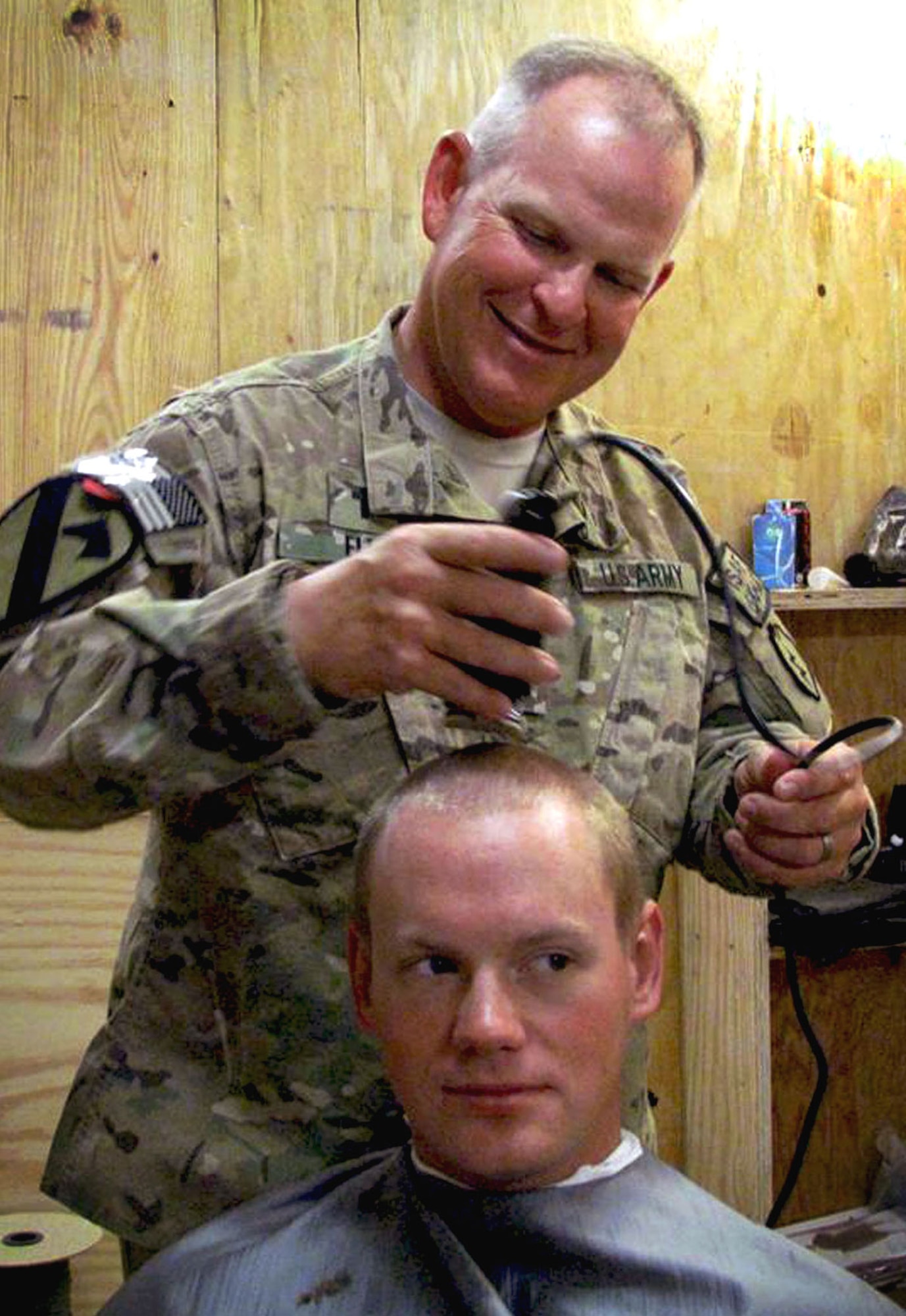 Army Chaplain (Capt.) Jeffrey Ellis, chaplain for 5th Squadron, 1st Cavalry Regiment, 1st Stryker Brigade Combat Team, 25th Infantry Division, trims a Soldier’s hair at the Frontenac Chapel at Shah Wali Kot, Afghanistan. Chaplin Ellis and his assistant, Spc. Corey Penton, provide haircuts to their Soldiers. “It puts (Penton) and me in the position to talk to a lot more Soldiers and see how they are doing,” Ellis said. (Photo by Capt. Michael Newman/5-1st Cavalry Regiment, 1-25th Stryker Brigade Combat Team)
