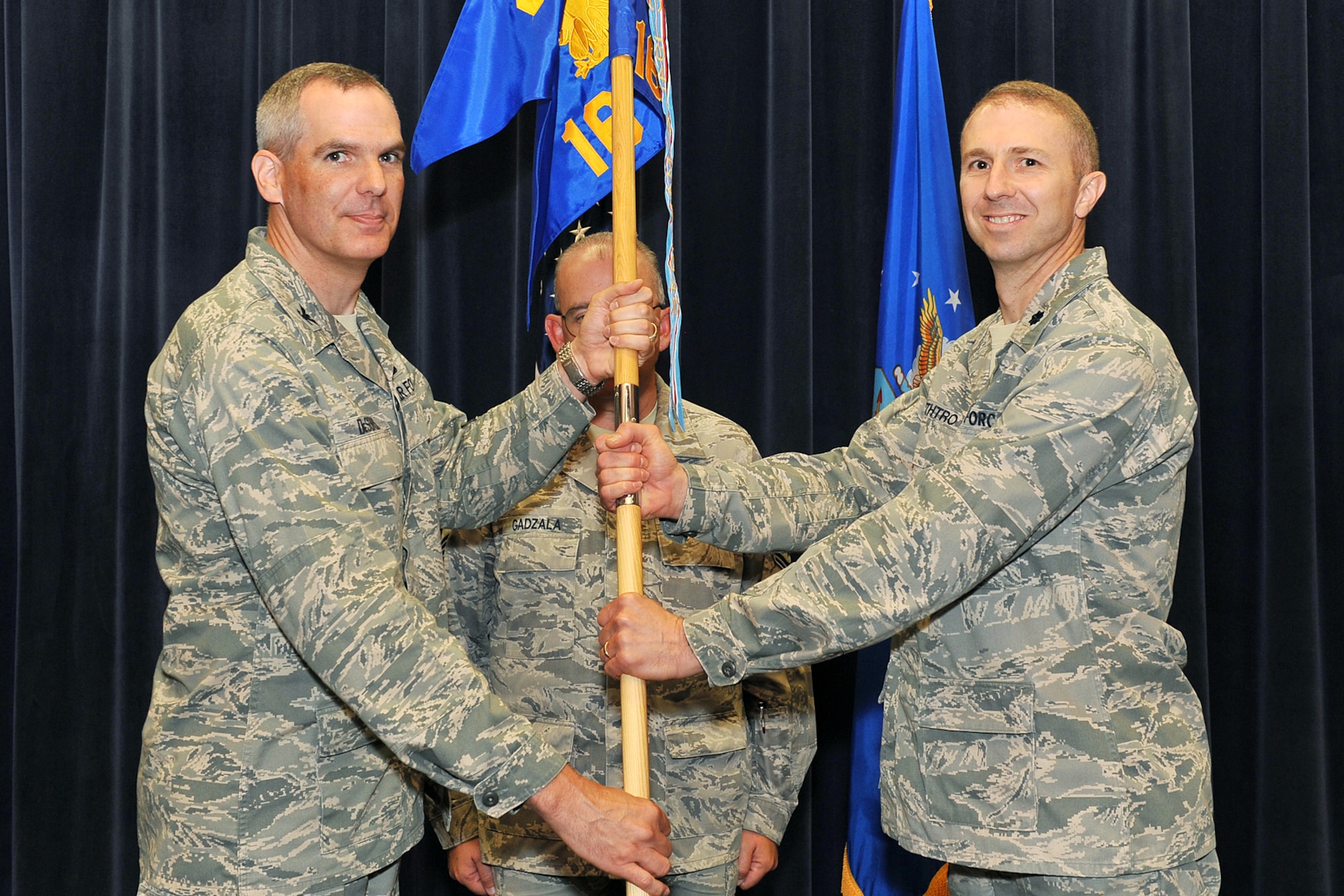 U.S. Air Force Col. Steven DeSordi, 2nd Weather Group commander, passes the guidon to Lt. Col.  Christopher Smithtro, incoming 16th Weather Squadron commander, during a change of command ceremony inside the Air Force Weather Agency auditorium on Offutt Air Force Base, Neb., on July 11. 

(U.S. Air Force Photo by Charles Haymond/Released)
