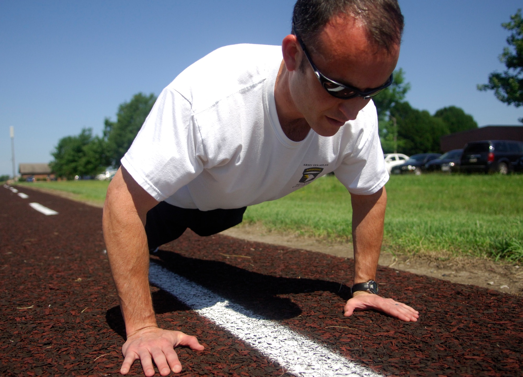 110629-F-DH715-048 – Maj. Mike Good, 618th Air Operations Center (TACC) Deputy Division Chief of the Distribution Channel Operations, does push-ups on base June 29, 2011. Major Good has gotten a 100 percent on nine out of the 10 PT tests he has taken. (U.S. Air Force photo/ Airman 1st Class Jake Eckhardt)