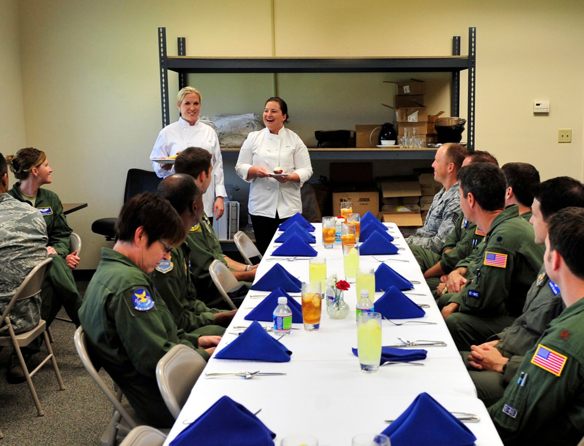 Staff Sgt. Amy Gillilan and Tech. Sgt. Danielle Sloan, flight attendants, describe the meal they prepared to an audience at Scott Air Force Base, Ill June 29, 2011. Sergeant Gillilan and Sloan will be representing Scott at the 2011 Rodeo in the culinary competition.  In preparation for the event they have been cooking meals with the secret ingredient “beef” for multiple audiences to get feedback and improve the meal.  (U.S. Air Force photo/Staff Sgt. Stephenie Wade)