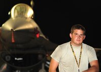 Airman 1st Class Benjamin Kroondyk, 79th Aircraft Maintenance Unit avionics systems apprentice, poses in front of an F-16 fighter jet at Shaw Air Force Base, S.C., July 1, 2011. Avionics specialists maintain the electronic aspects and logistic readiness of an aircraft. (U.S. Air Force photo/Airman 1st Class Neil D. Warner) (Released)
