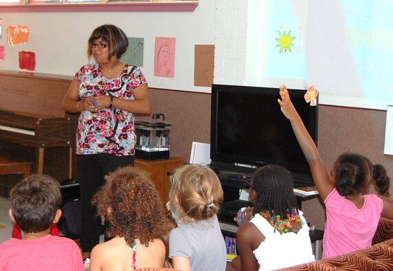 LAUGHLIN AIR FORCE BASE, Texas - - Carla Chavez, 47th Flying Training Wing summer-hire employee, asks the children of Laughlin’s youth center a question following her presentation on the dangers of talking to strangers. This presentation took place at the youth center July 13 for children to learn basic stranger safety tips. (U.S. Air Force photo by Laura Salazar)