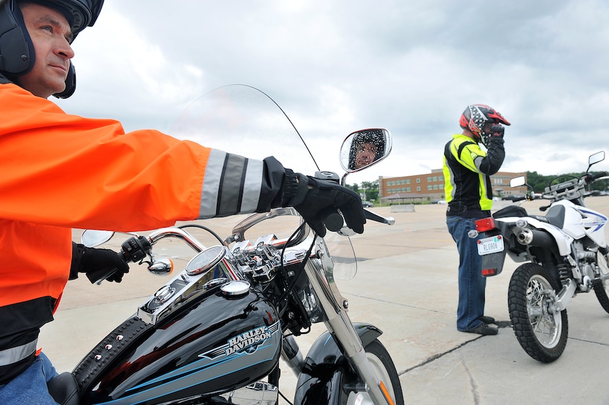 U.S. Air Force Brig. Gen. Donald Bacon, 55th Wing commander, sits on his motorcycle while an instructor teaches the Basic Riders Course 2 motorcycle training class in the Air Force Weather Agency parking lot on Offutt Air Force Base, Neb., on July 7. (U.S. Air Force Photo by Charles Haymond/Released)