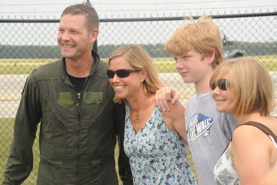 U.S. Air Force Col. Gary Henderson, 23rd Wing commander, shares a moment with his wife Erin and children Calvin and Katie after his return from his fini-flight on an HH-60G Pave Hawk at Moody Air Force Base, Ga., July 12, 2011. The fini-flight is a long-standing Air Force tradition that happens when a commander departs from the base. (
U.S. Air Force photo by Airman 1st Class Paul Francis/Released)
