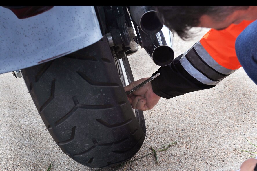 U.S. Air Force Photo Brig. Gen. Donald Bacon, 55th Wing commander, checks the pressures of this tire during a T-Clock inspection outside in the Air Force Weather Agency parking lot on Offutt Air Force Base, Neb., on July 7.  General Bacon is participating in the Basic Riders Course 2 motorcycle training class. 

(U.S. Air Force Photo by Charles Haymond/Released)
