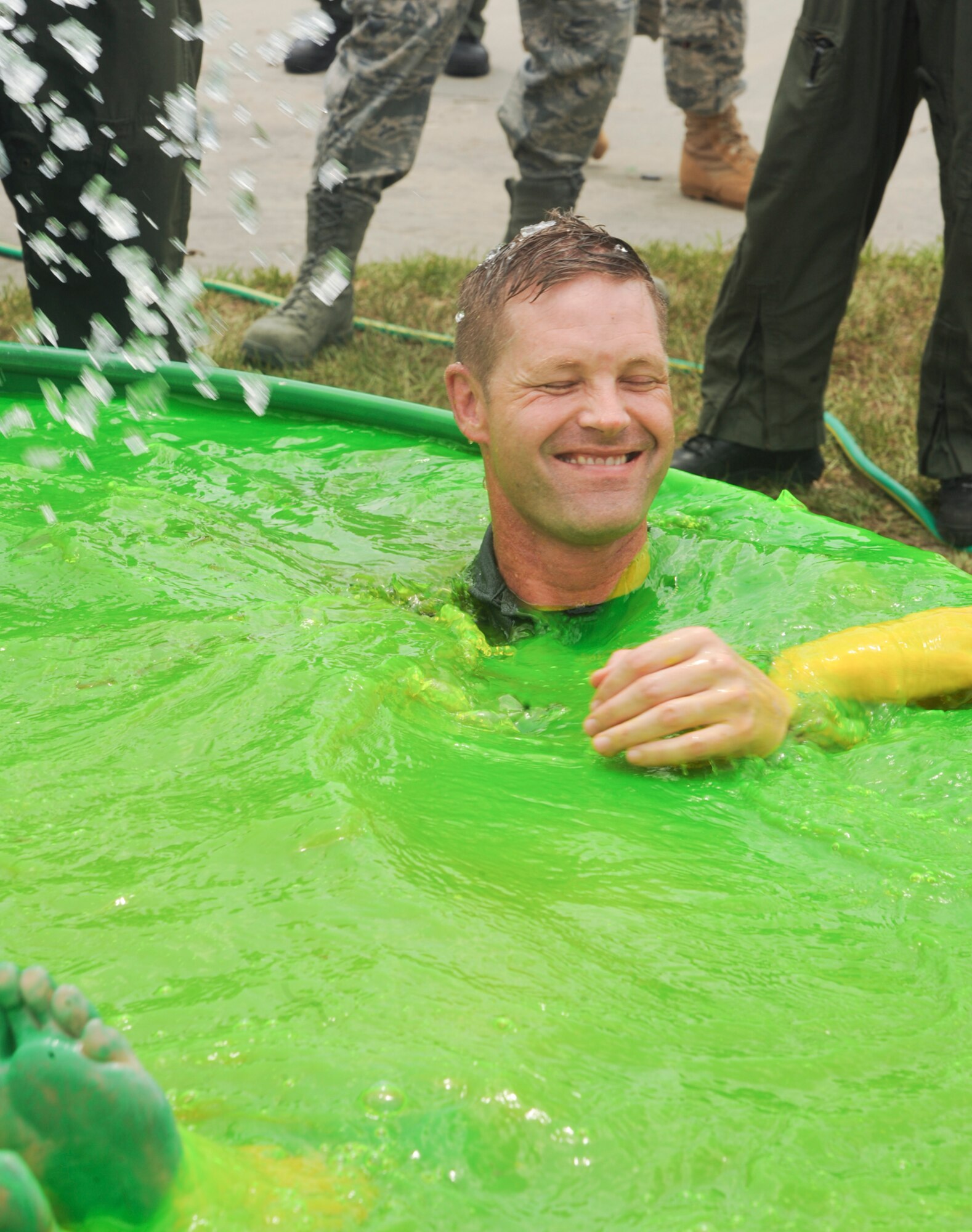 U.S. Air Force Col. Gary Henderson, 23rd Wing commander, is thrown into a green pool after landing from his final flight in an HH-60G Pave Hawk at Moody Air Force Base, Ga., July 12, 2011. The flight was Henderson’s last as 23rd WG commander before departing for Ramstien Air Base, Germany. (U.S. Air Force photo by Airman 1st Class Paul Francis/Released)