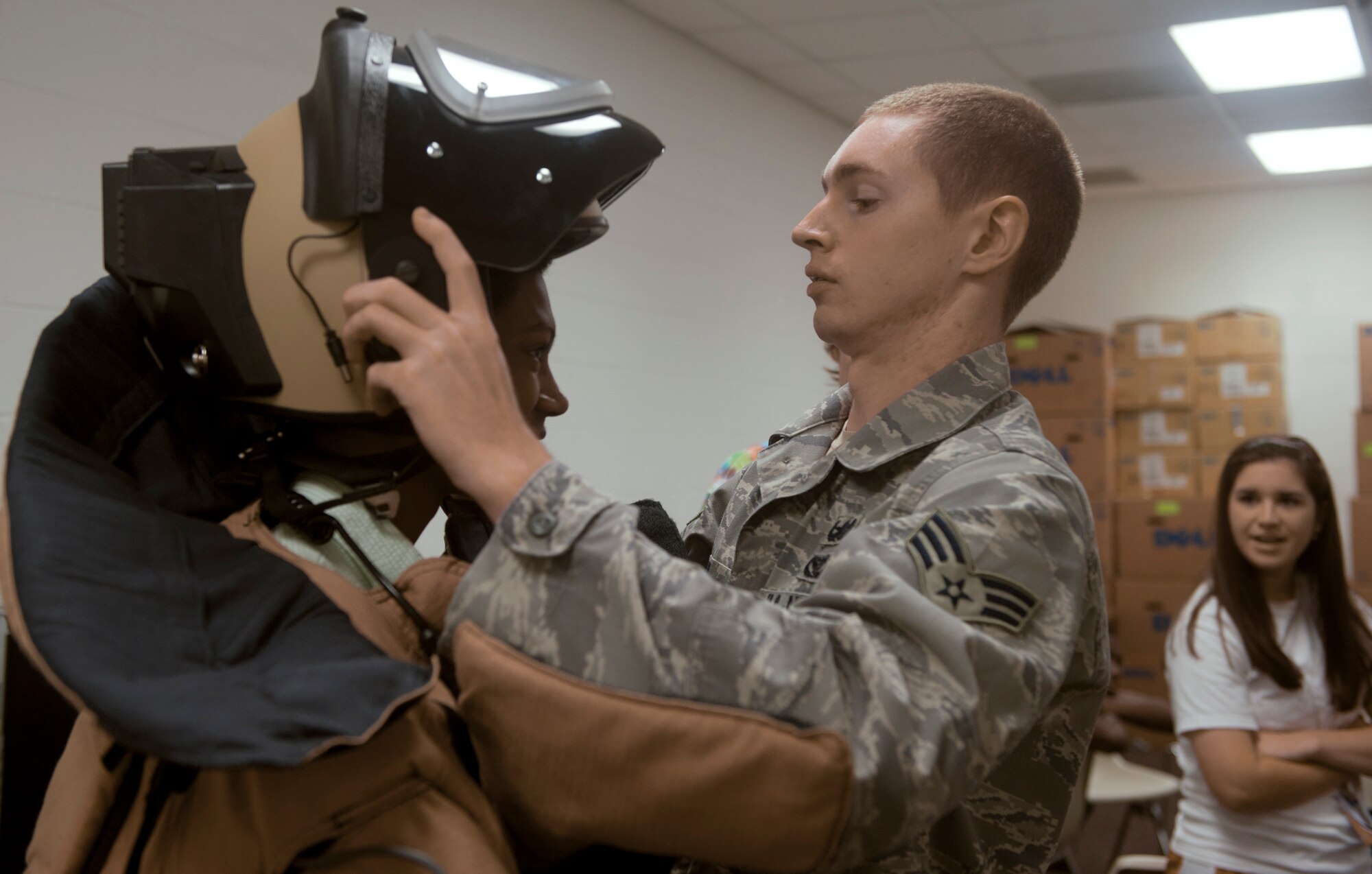 Senior Airman Justin Smith, 23rd Civil Engineer Squadron explosive ordnance disposal journeyman, places the EOD 9 bomb suit onto Alex Gradey, a Governor’s Honors Program student, at Valdosta State University in Valdosta, Ga., July 12, 2011. The bomb suit is used by EOD members to manually diffuse a bomb when a robot is incapable of doing so. (U.S. Air Force photo by Airman 1st Class Nicholas Benroth/Released)