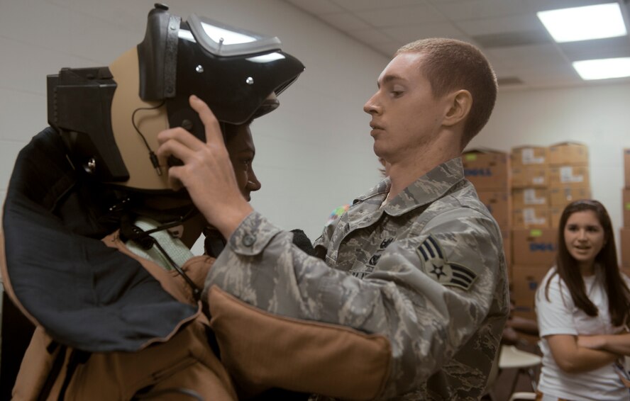 Senior Airman Justin Smith, 23rd Civil Engineer Squadron explosive ordnance disposal journeyman, places the EOD 9 bomb suit onto Alex Gradey, a Governor’s Honors Program student, at Valdosta State University in Valdosta, Ga., July 12, 2011. The bomb suit is used by EOD members to manually diffuse a bomb when a robot is incapable of doing so. (U.S. Air Force photo by Airman 1st Class Nicholas Benroth/Released)
