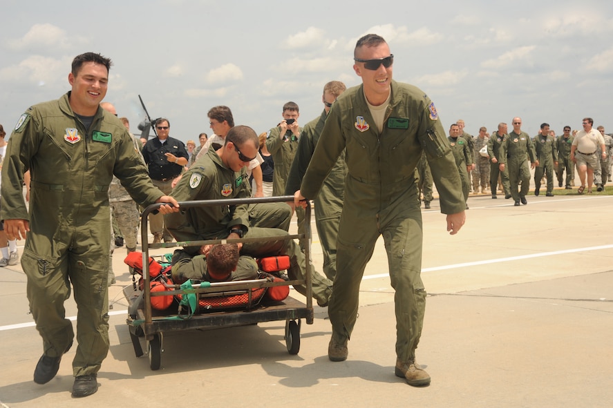 U.S. Air Force Col. Gary Henderson, 23rd Wing commander, is bound and carted off the flightline at Moody Air Force Base, Ga., July 12, 2011.  Fellow pilots threw Henderson into a tub of ice and then into a water-filled pool to celebrate his final flight as wing commander. (U.S. Air Force photo by Airman 1st Class Paul Francis/Released)