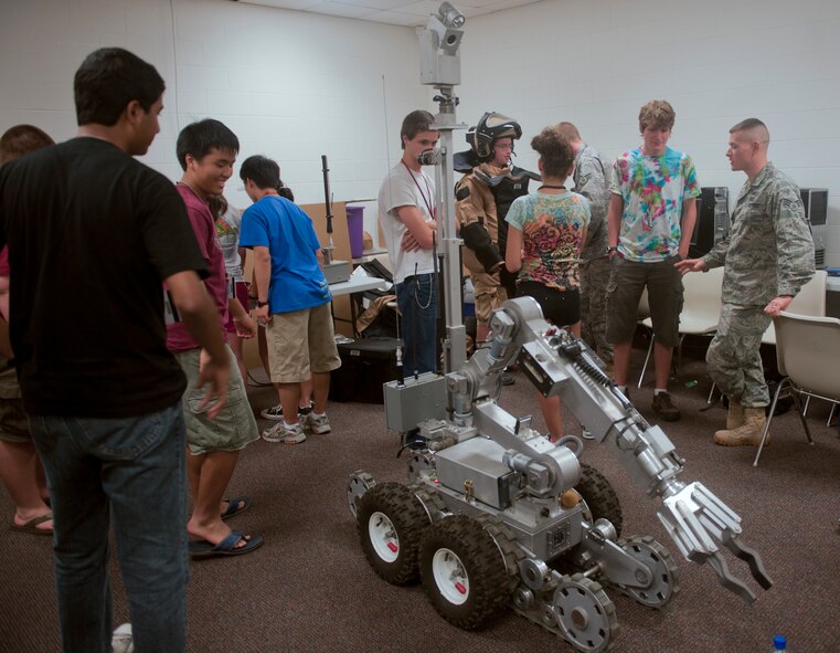 Two Airmen from the 23rd Civil Engineer Squadron explosive ordnance disposal unit, demonstrate the capabilities of the F-6A EOD robot to members of the Governor’s Honors Program technology course at Valdosta State University in Valdosta, Ga., July 12, 2011. Students of the program were chosen from across Georgia based on academic excellence. (U.S. Air Force photo by Airman 1st Class Nicholas Benroth/Released)