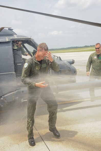 U.S. Air Force Col. Gary Henderson, 23rd Wing commander, is showered by his family after taking his final flight in an HH-60G Pave Hawk at Moody Air Force Base, Ga., July 12, 2011. Henderson has served as 23rd WG commander for two years and is moving to become deputy commander of 3rd Air Force at Ramstein Air Base, Germany. (U.S. Air Force photo by Airman 1st Class Paul Francis/Released)