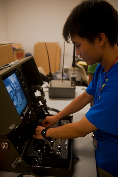Kevin Fan, a student of the Governor’s Honors Program, uses the controls to move an F-6A explosive ordinance disposal robot during a visit by two EOD Airmen at Valdosta State University in Valdosta, Ga., July 12, 2011. The students had the opportunity to learn about EOD and how to control the robot’s movements. (U.S. Air Force photo by Airman 1st Class Nicholas Benroth/Released)