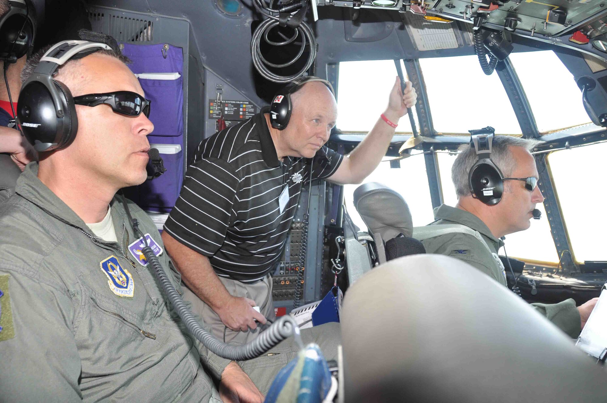 Bob Hawkins, 934th Security Forces Squadron honorary commander gets a look at the flight deck of a 934th Airlift Wing C-130 during the honorary commanders orientation flight June 30. (Air Force Photo/Paul Zadach)