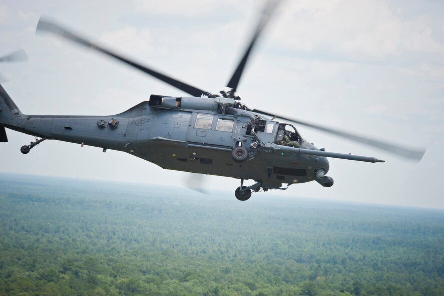An HH-60G Pave Hawk flown by Col. Gary Henderson, 23rd Wing commander, flies over the skies of the Grand Bay Bombing and Gunnery Range during a training mission with the 41st Rescue Squadron, July 12, 2011. During the mission, Henderson performed various aerial maneuvers in response to simulated combat scenarios. Aerial gunners on board also practiced hitting targets on the range. (U.S. Air Force photo by Staff Sgt. Jamal D. Sutter/Released)