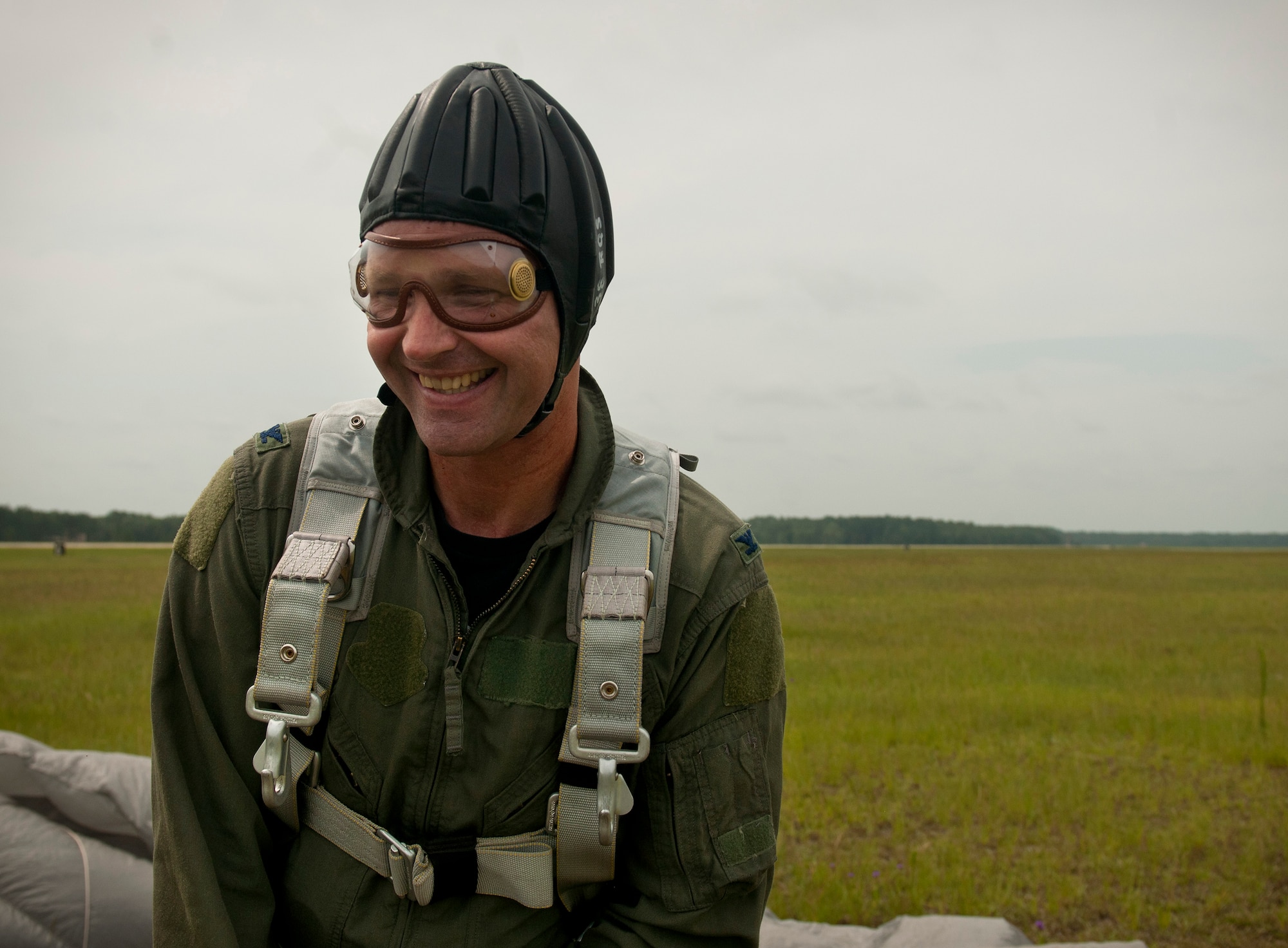 U.S. Air Force Col. Gary Henderson, 23rd Wing commander, is all smiles after his tandem jump with an Airman from the 38th Rescue Squadron during his final flight at Moody Air Force Base, Ga., July 12, 2011. The event was part of Henderson’s fini-flight. Afterward, he drove an all-terrain vehicle, flew an HH-60G Pave Hawk and was greeted by family, friends and Airmen of Moody. (U.S. Air Force photo by Airman 1st Class Joshua Green/Released)
