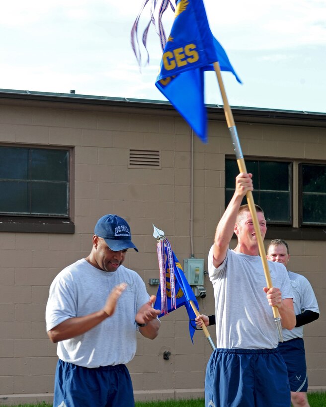 Col. Trent Edwards, 28th Mission Support Group commander, congratulates Staff Sgt. Andrew Warnement, 28th Civil Engineer Squadron engineering technician, on winning the Warrior Run for his squadron at Ellsworth Air Force Base, S.D., June 30, 2011. While promoting safety and wellness was the overall goal of this run, Warnement’s victory also won the 28th CES a day off. (U.S. Air Force photo/Airman Alystria Maurer)