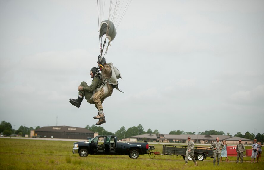 U.S. Air Force Tech. Sgt. Mark Panzera, 38th Rescue Squadron pararescueman, and Col. Gary Henderson, 23rd Wing commander, parachute down from the sky during a tandem jump from an HC-130P Combat King for Colonel Henderson’s final flight at Moody Air Force Base, Ga., July 12, 2011. (U.S. Air Force photo by Airman 1st Class Joshua Green/Released)
