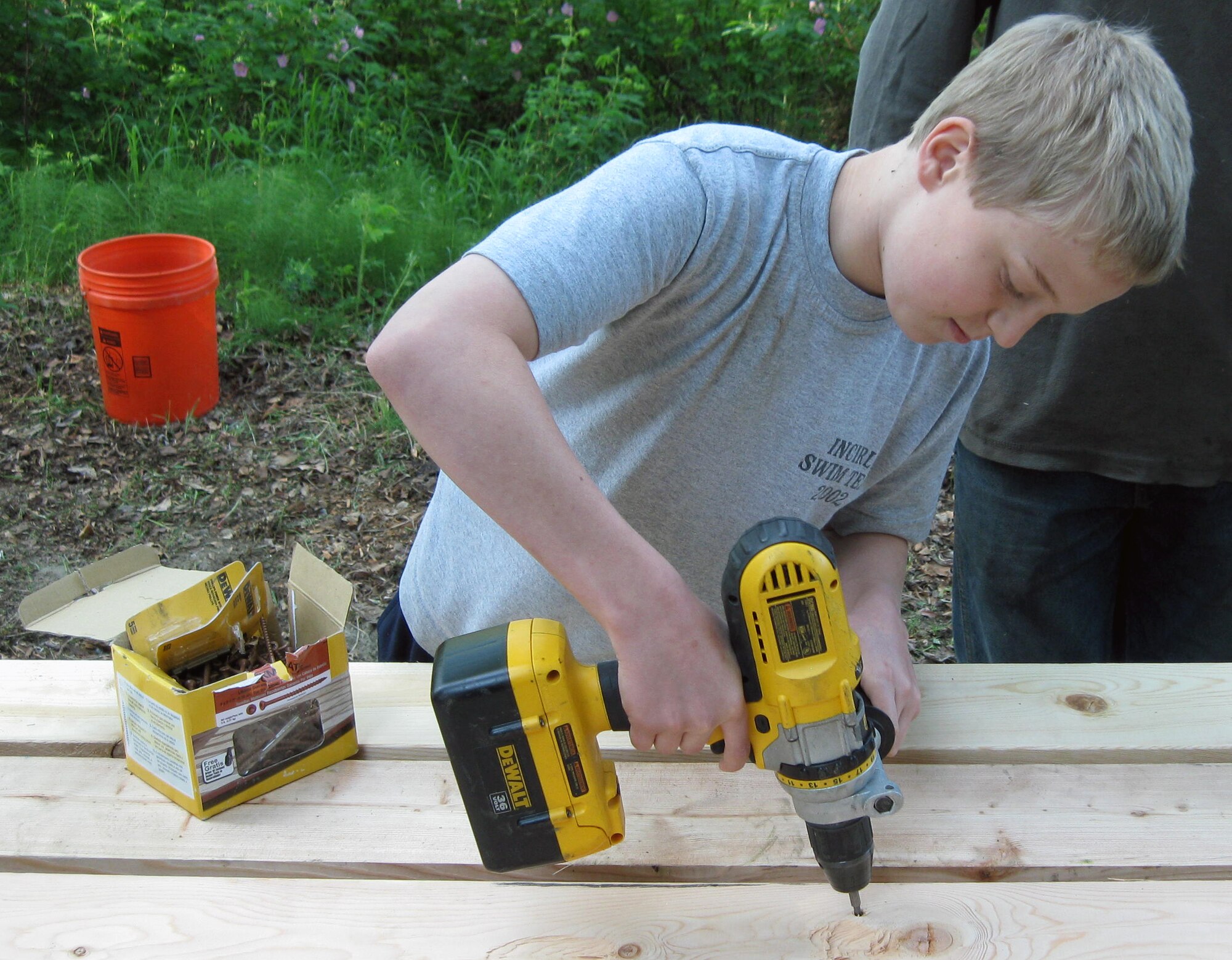 Ben Sutter drills a picnic table together June 11, 2011, Eielson Air Force Base, Alaska.  The renovation project was one of several to campgrounds belonging to the installation over the last few years and helped remind people of the growing need for taking care of campgrounds and picnic sites.  Ben is the son Chaplain (Lt. Col.) Paul Sutter, 354th Fighter Wing chaplain.  (Courtesy Photo)