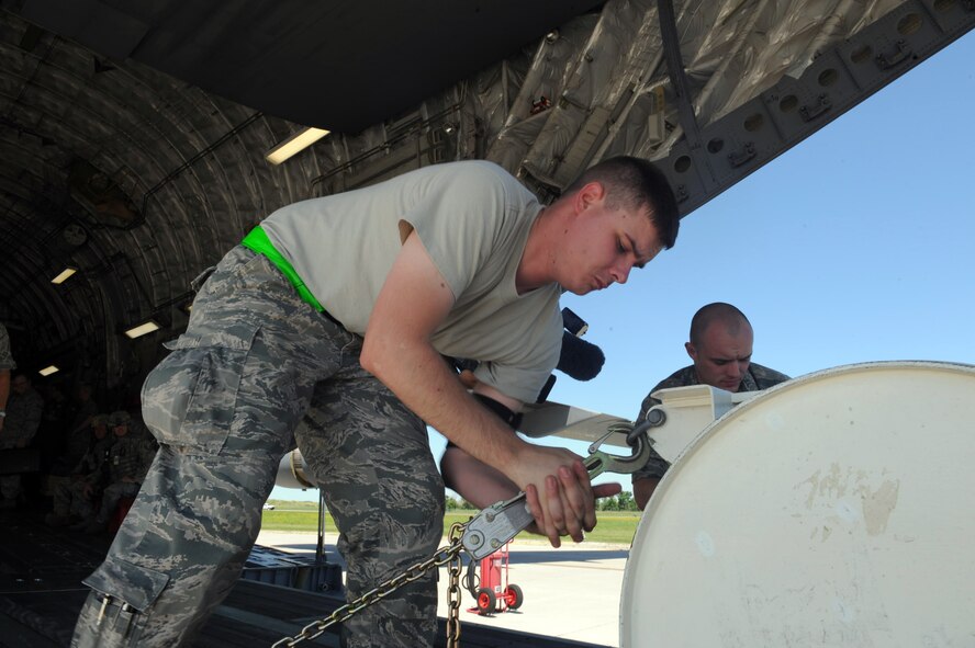 MINOT AIR FORCE BASE, N.D. -- Staff Sgt. Chris Griffiths, 17th Munitions Squadron weapons maintenance team chief, secures a simulated weapon during the Special Assignment Airlift Mission Exercise here July 7. The SAAMEX is designed to keep Airmen combat-ready at all times. The SAAMEX hasn’t been performed at Minot AFB in more than two years. (U.S. Air Force photo/Senior Airmen Michael J. Veloz) 