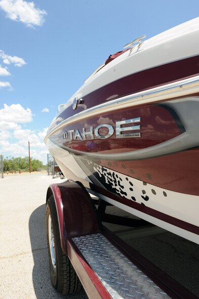 DYESS AIR FORCE BASE, Texas-- A boat sits in the storage area behind the Outdoor Recreation center here July 13, 2011. Boating equipment is one of a few pieces of equipment offered by Outdoor Recreation for rental; other available equipment includes lawn and garden tools, tables and chairs, trailers, camping gear, air castles and even dunking booths. In addition, Outdoor Recreation offers different past time activities to include a paintball field and batting cage. (U.S. Air Force photo by Airman 1st Class Courtney Moses)