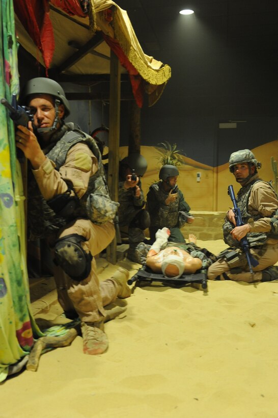 Air mobility air advisors from the 621st Contingency Response Wing provide security at a simulated casualty collection point as Lt. Col. Thom Adkins, 818th Mobility Support Advisory Squadron commander, radios in a medical evacuation “nine-line” request during U.S. Army Combat Lifesaver training at Joint Base McGuire-Dix-Lakehurst N.J., here June 8. The mobility Airmen were the first to attend training specifically tailored for missions in Africa and South America. Air Advisors will assist partner nations as they expand their air mobility systems. (U.S. Air Force photo by 1st Lt Brooke Brzozowske)