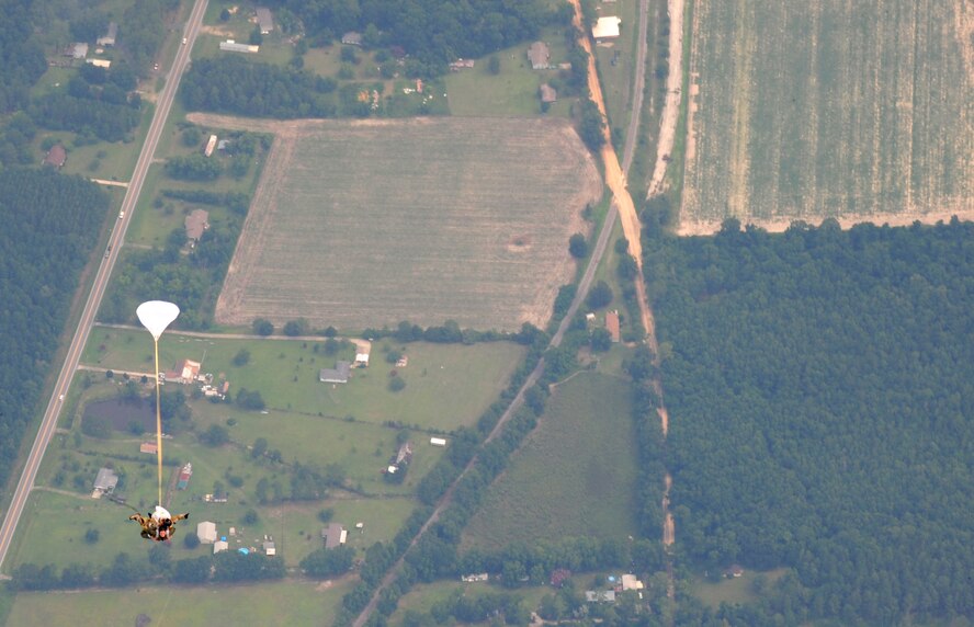 U.S. Air Force Col. Gary Henderson, 23rd Wing commander, and Tech. Sgt. Mark Panzera, 38th Rescue Squadron pararescueman, parachute down to a drop zone at Moody Air Force Base, Ga., July 12, 2011. The jump was part of Colonel Henderson’s fini-flight before his permanent change of station to Ramstein Air Base, Germany, where he will serve as the deputy commander of the 3rd Air Force. (U.S. Air Force photo by Senior Airman Stephanie Mancha/Released)