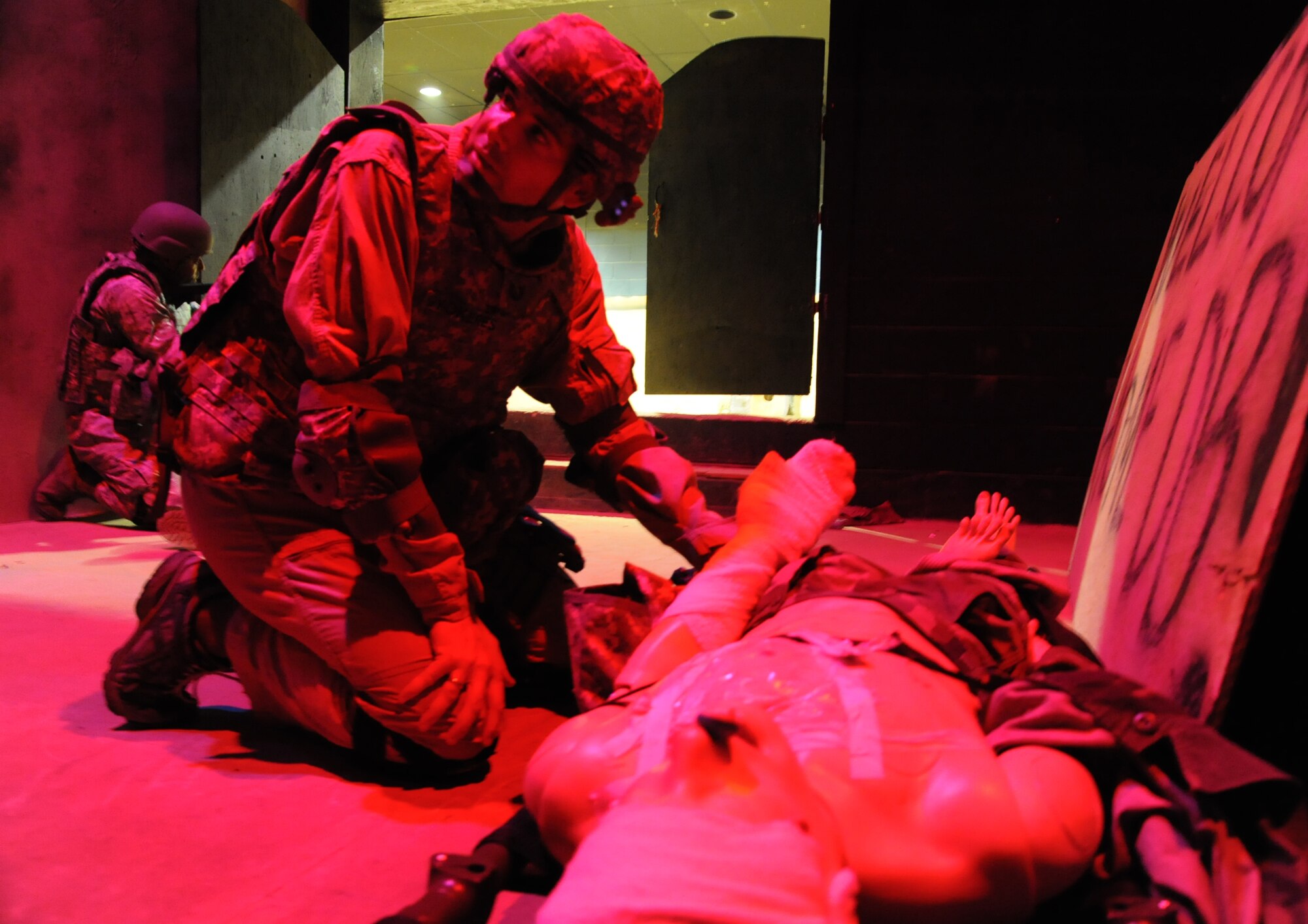 Tech. Sgt.  Parker Gyokeres, 621st Contingency Response Wing public affairs journalist, performs a casualty assessment after movement during U.S. Army Combat Lifesaver training at Joint Base McGuire-Dix-Lakehurst N.J., here June 8.  Gyokeres and nine other members of the 621st CRW were part of the first graduating class of air mobility air advisors trained to perform missions in Africa and South America. (U.S. Air Force photo by 1st Lt Brooke Brzozowske) 