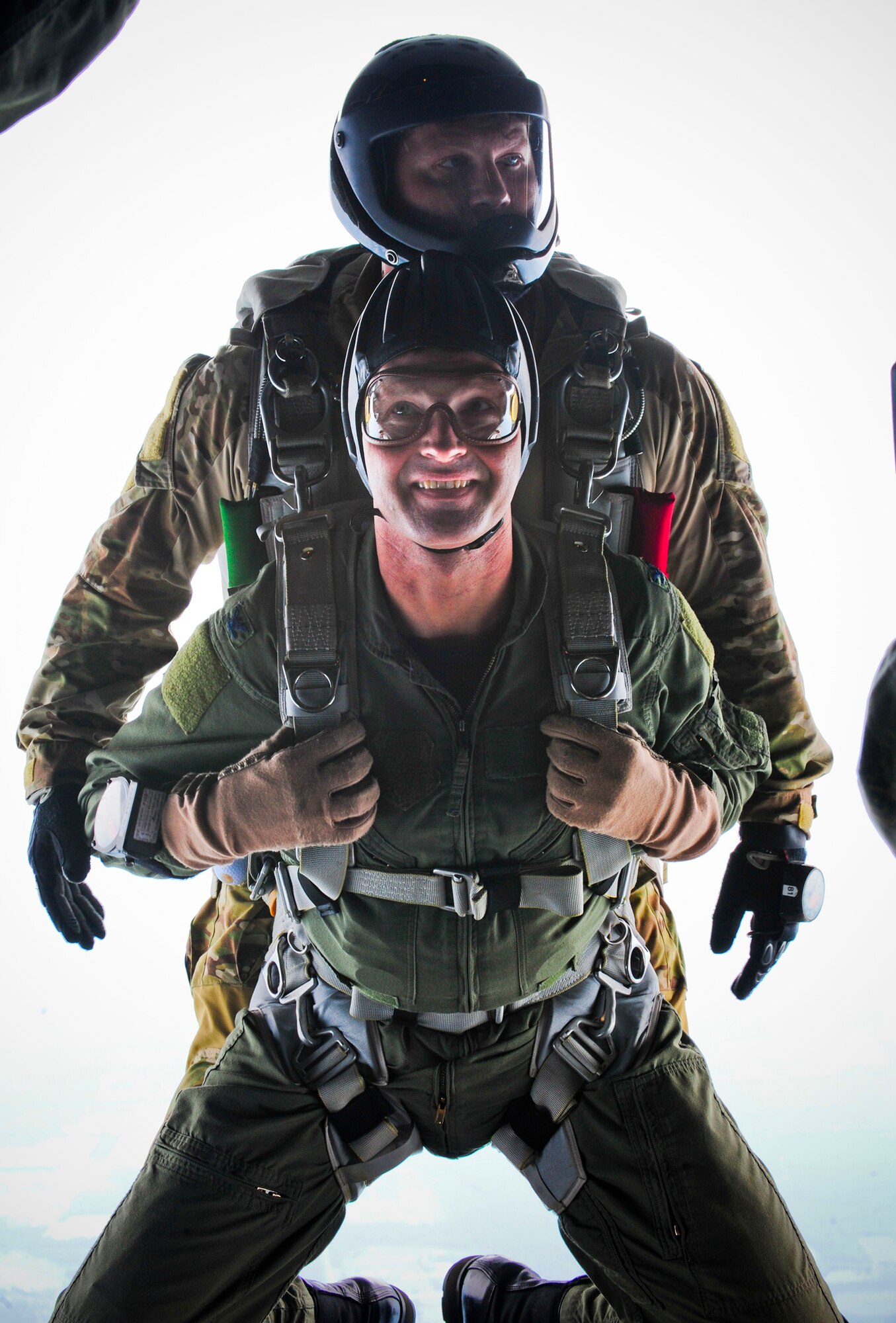 U.S. Air Force Col. Gary Henderson 23rd Wing commander, and Tech. Sgt. Mark Panzera, 38th Rescue Squadron pararescueman, prepare to jump off an HC-130P Combat King at Moody Air Force Base, Ga., July 12, 2011. The jump was part of Colonel Henderson’s final or “fini” flight, a long-standing Air Force tradition that traces its roots back to the Vietnam War where pilots would commemorate their final mission. (U.S. Air Force photo by Senior Airman Stephanie Mancha/Released)