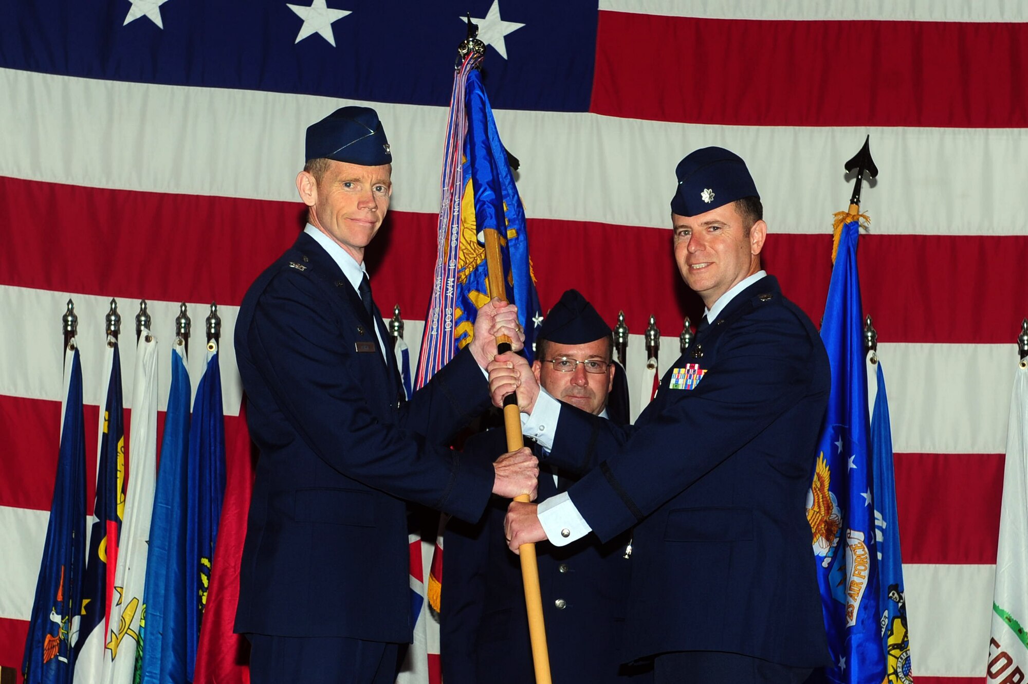 MINOT AIR FORCE BASE, N.D. -- Lt. Col. Eric Froehlich, 5th Maintenance Group commander, assumes command from Col. James Dawkins, 5th Bomb Wing commander, during a change of command ceremony here July 11. The change of command ceremony is one of the Air Force’s time-honored traditions. (U.S. Air Force photo/Senior Airman Michael J. Veloz)