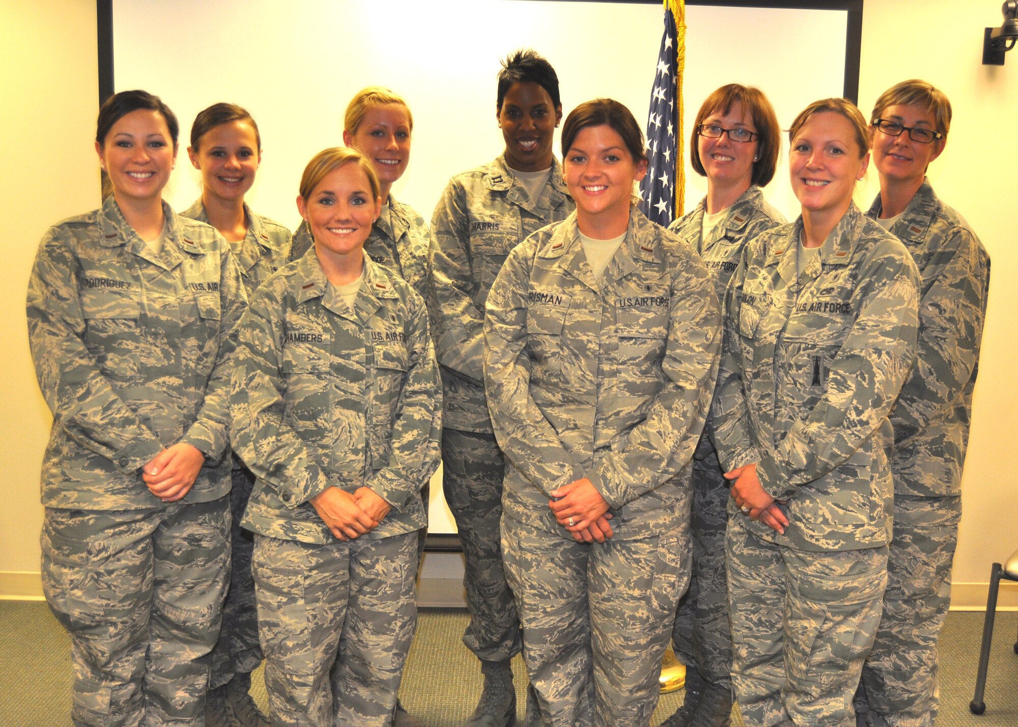 Graduates of the last Keesler Nurse Transition Program class stand with program chief Capt. Iesiah Harris, back row center, following their June 22 graduation ceremony.  Col. Allison Plunk, 81st Medical Group chief nurse, presented their certificates and addressed the class and guests.  The class selected Capt. Shawnice Shankle, 81st Medical Operations Squadron, as their guest speaker and 1st Lt. Heidi Hautala, 81st Inpatient Operations Squadron, was named outstanding preceptor.  The new Air Force nurses and their follow-on assignments are, front row from left, 2nd Lts. Beverly Rodriguez, Eglin Air Force Base, Fla.; Tiffany Chambers, Keesler; Kerri Erishman and Jessica Colon, Eglin AFB.  Back row from left: 2nd Lts. Hailey Ott, Keesler; Olivia Eldridge, Nellis AFB, Nev.; Kristin Blouin, Yokota Air Base, Japan, and Cristi Dueker-Bray, Keesler.  (U.S. Air Force photo by Steve Pivnick)