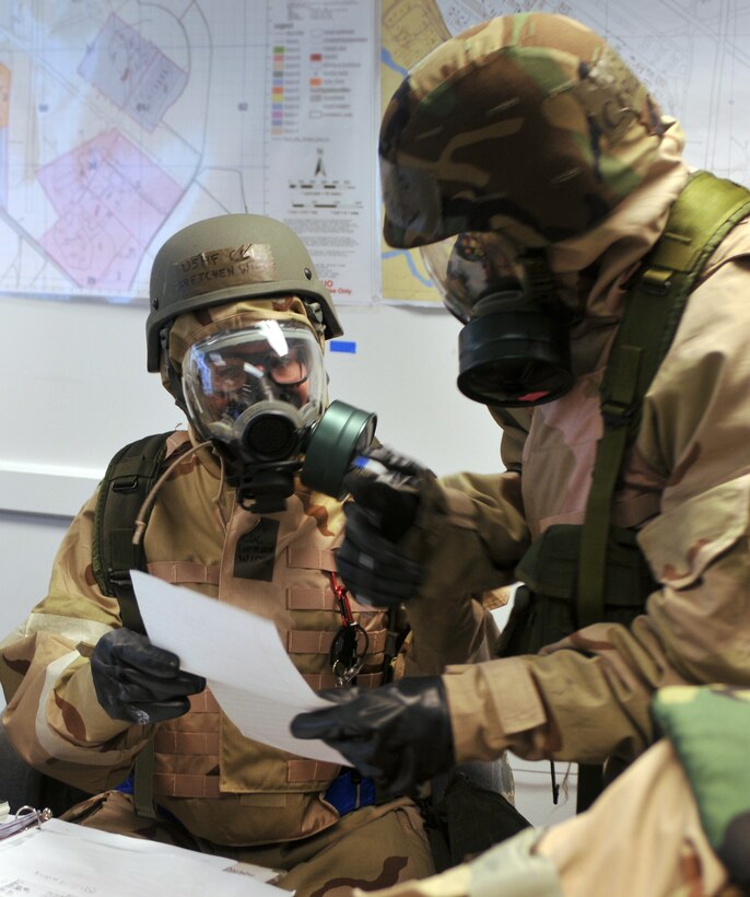 Senior Master Sgt. Cornell Jolley, 512th Civil Engineer Squadron Emergency Management manager, right, discusses emergency management options with Col. Gretchen M. Wiltse, Emergency Operations Center commander and 512th Mission Support Group commander, during a simulated chemical attack at Dover Air Force Base, Del., July 9, 2011.  The exercise is preparation for the Operational Readiness Inspection the 512th and 436th Airlift Wings will undergo in December, 2011. ORIs are conducted to evaluate and measure the ability of a unit to perform in wartime, during a contingency or a force sustainment mission. (U.S. Air Force photo by Capt. Marnee A.C. Losurdo)
