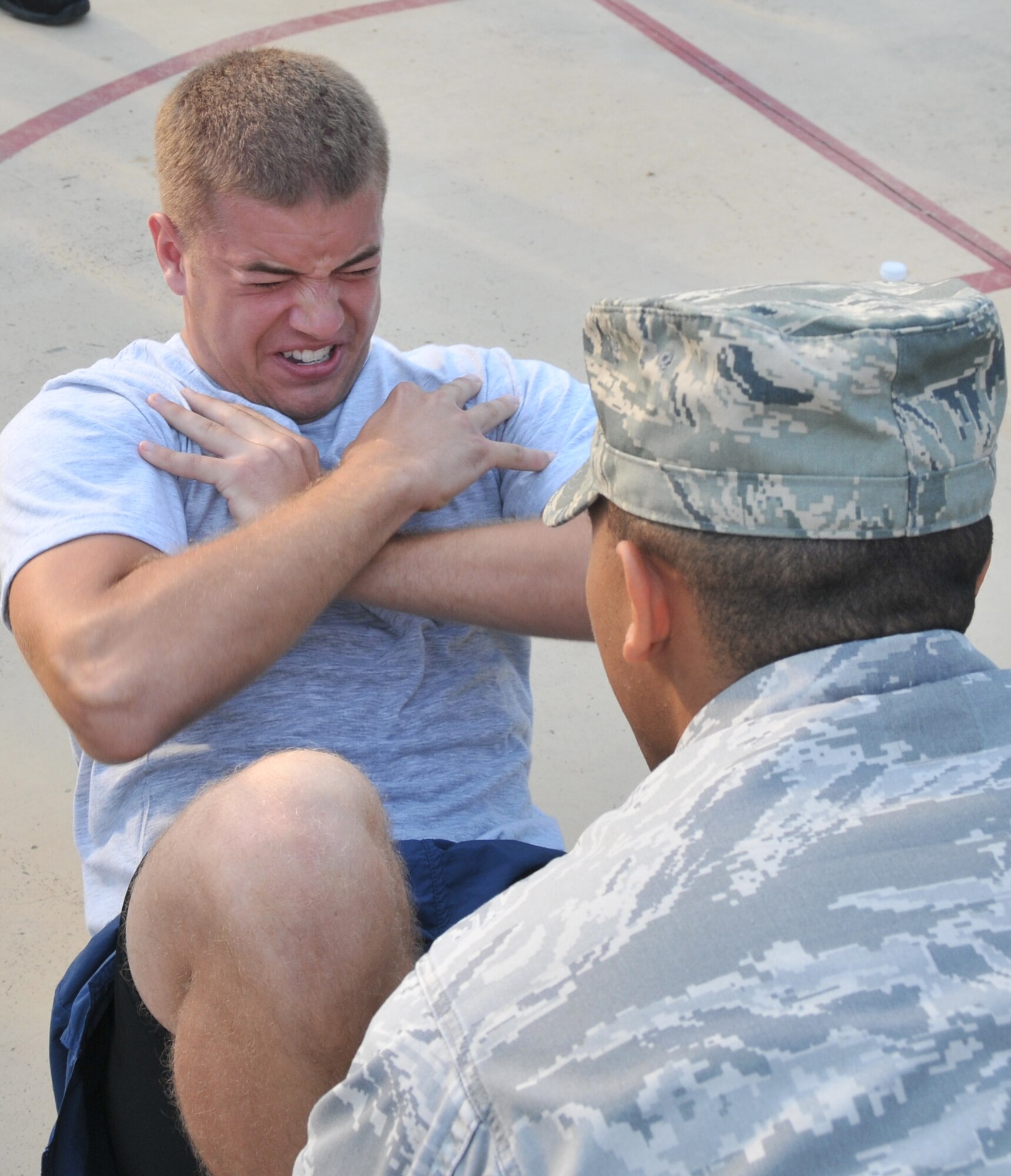 Airman 1st Class Herschell Miller represented his dorm in a sit up contest during the Dorm Excellence Warrior Ethos challenge July 12 on Joint Base Charleston - Air Base. Airmen had one minute to do as many sit ups as possible. Miller is a 437th Maintenance Squadron Precision Measurement Equipment Laboratory technician. (U.S. Navy photo /Yeoman Third Class Timothy Daughton)
