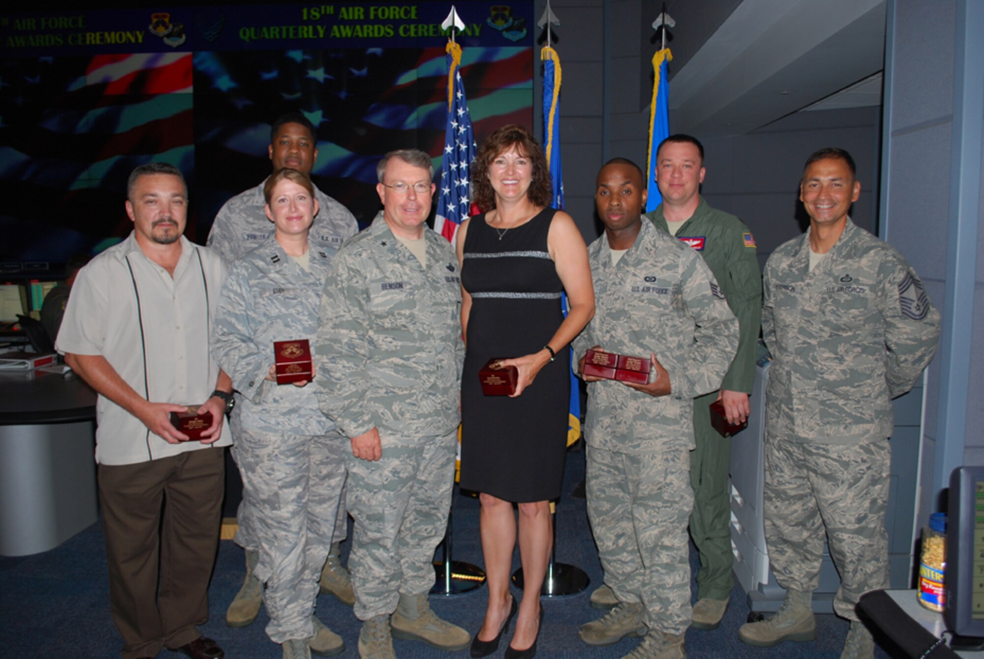 SCOTT AFB, IL -- Brig. Gen. Bryan Benson, Deputy Commander, 18th Air Force (center) and Chief Master Sgt. Andrew Henderson, 618th Air and Space Operations Center (Tanker Airlift Control Center) Superintendent (far right), presented the command's hadquarters-level second quarter awards here July 12.  

From left to right, Douglas Rader, Civilian of the Quarter, Category II; Capt. Faith Eudy, Company Grade Officer of the Quarter; Senior Airman Jamar Fowler, Junior Enlisted Member of the Quarter; Lara Morrison, Civilian of the Quarter, Category III; Staff Sgt. Joseph Venable, NCO and Volunteer of the Quarter; and Maj. Nicholas Schindler, Field Grade Officer of the Quarter.  Not pictured:  Master Sgt. Richard Martin, Senior NCO of the Quarter and Mrs. Ann Lomax, Civilian of the Quarter, Category I. (U.S. Air Force Photo/1st Lt. Marshel Slater).
